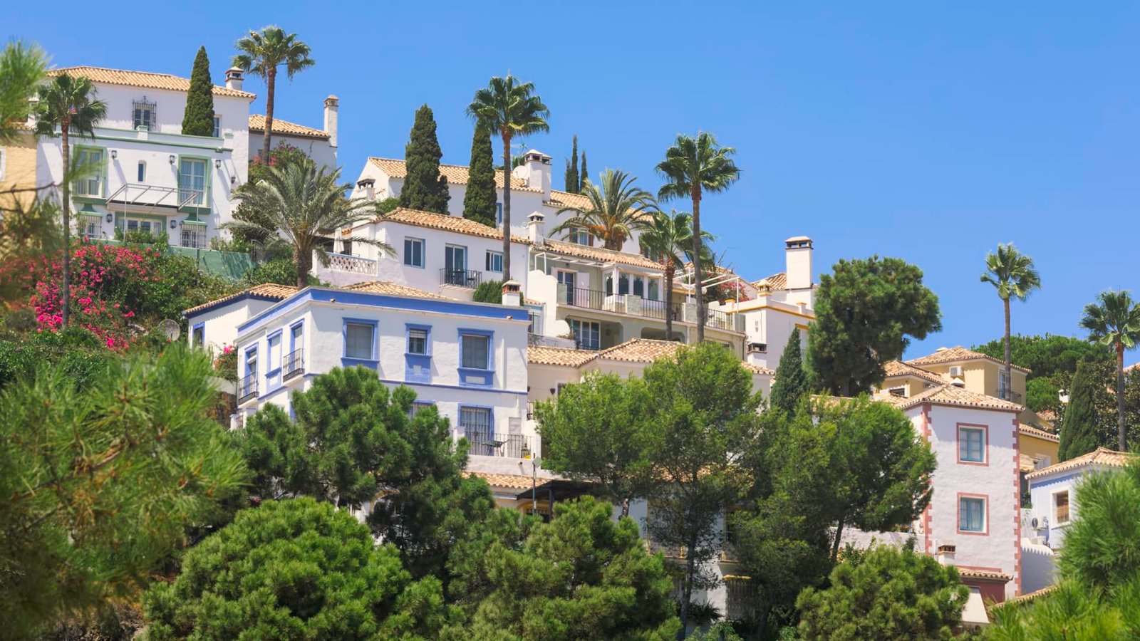 Why does Spain plan to impose a 100% tax on homes purchased by non-EU residents?